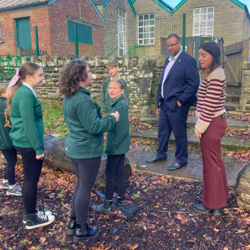 Matt Bishop MP exploring the outdoor grounds at Parkend Primary with Mrs K. Burke and pupils.