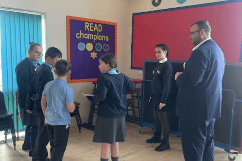 Matt Bishop MP discussing school values with pupils during his visit to Yorkley Primary School.