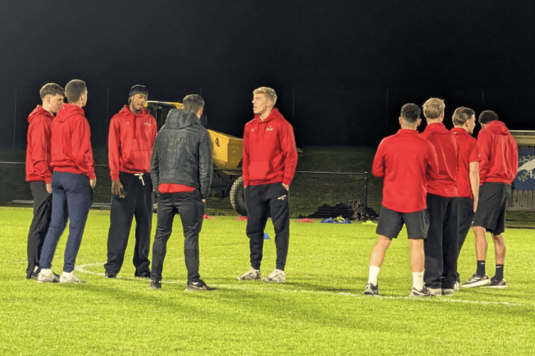 Hartpury FC players gather on the pitch at the 4ED Hartpury Stadium before kick-off in their first home match of 2026 against Shaftesbury AFC.