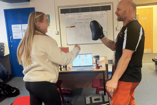 A student takes part in a high-energy boxing session with Forest Fighting Fit, practising techniques to stay safe.