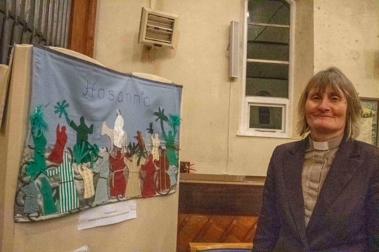Rev Michelle Ireland with a Palm Sunday work by the Methodist chapel's art group.