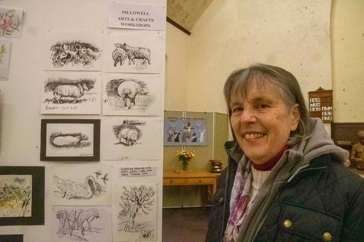 Rosalie Joynson with peen and ink ddrawings from the group.