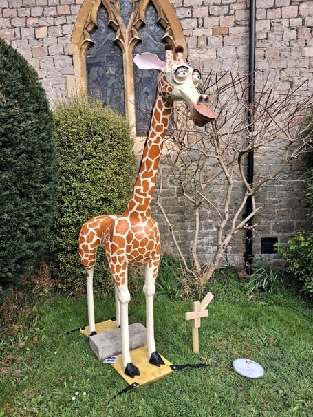 A giraffe outside a local landmark.