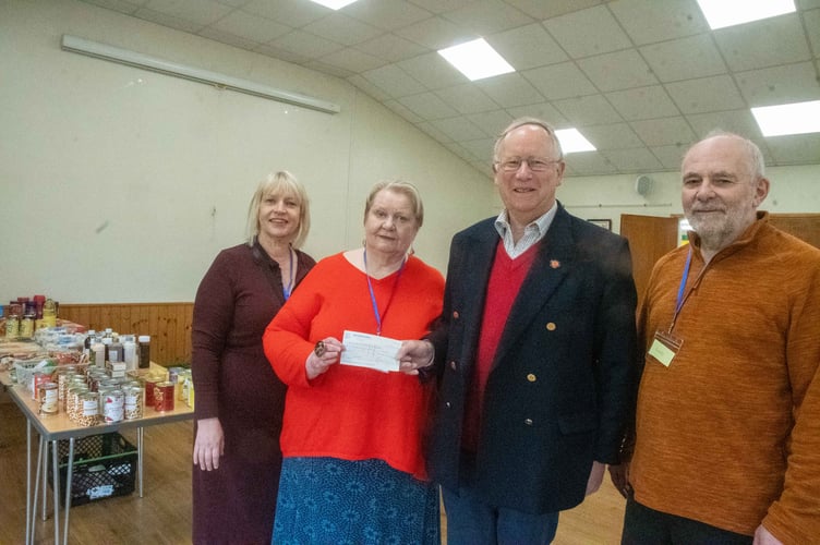 Chair of the Mitcheldean Community Later Maggie Mortimer is presented with a cheque by Andrew Tabor of the Honourable Company of Gloucestershire Charitable Trust. Also pictured are Larder treasurer Nicola Taylor and volunteer Richard Mortimer.