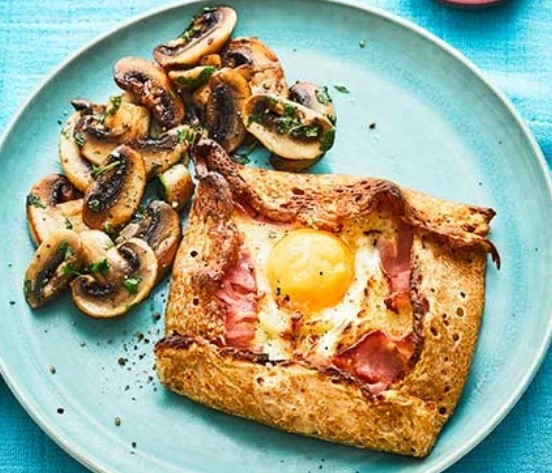 As a main course, savoury elements are added after the galette is cooked on one side, then flipped.
