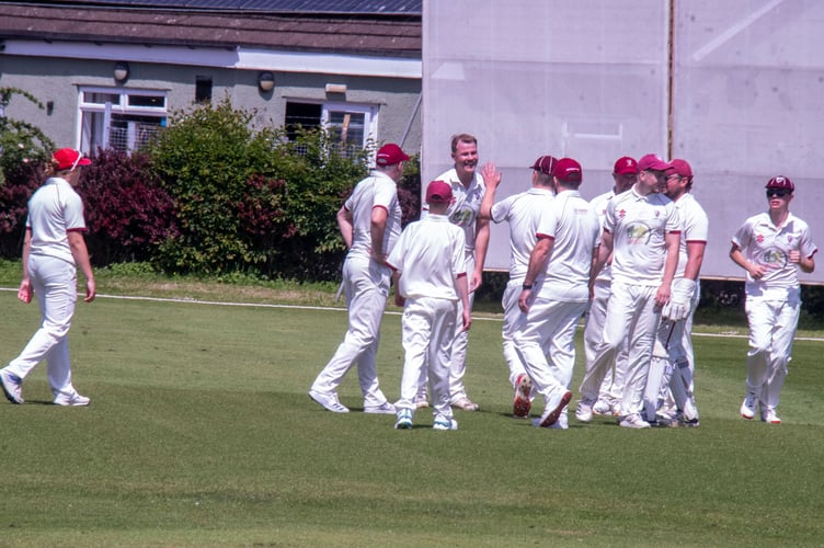 Niall Halford celebrates a wicket with Lydney team mates.
