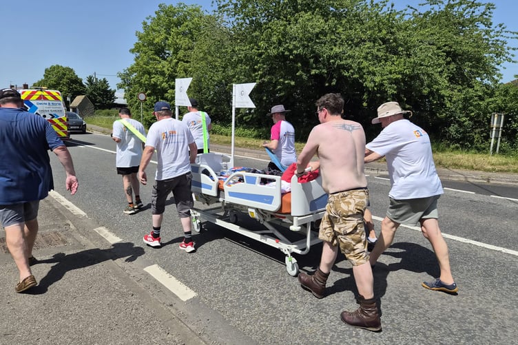 Participants make their way along the A48 during the charity bed push from Gloucester to Newnham-on-Severn, raising more than £2,100 for two good causes.
