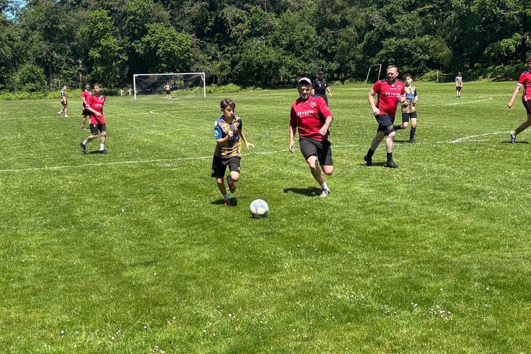 Yorkley Youth AFC players take on the dads' team during a friendly match held as part of the club's family fun day and youth launch event.