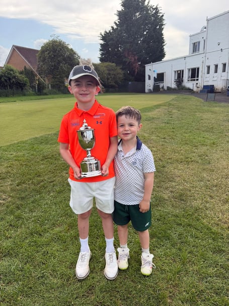 Taio Blake Burkitt and his brother at the golfing tournament.