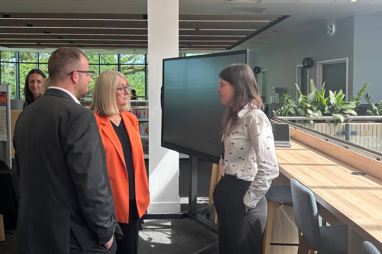 Baroness Jacqui Smith and Matt Bishop speak with medical microbiology researcher Libby Nicklin during their visit to the new learning hub.
