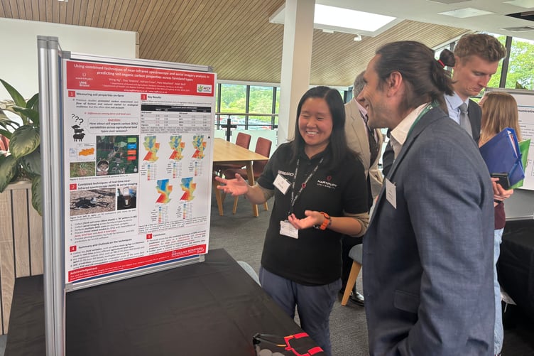 Forest of Dean District Council's Jonathan Lane discusses agricultural engineering research with postgraduate student Wing Ng during the opening event.