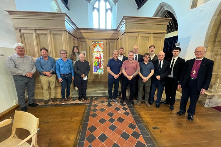 Members of the project with Bishop Anthony in front of the stained glass panel that had been in storage.