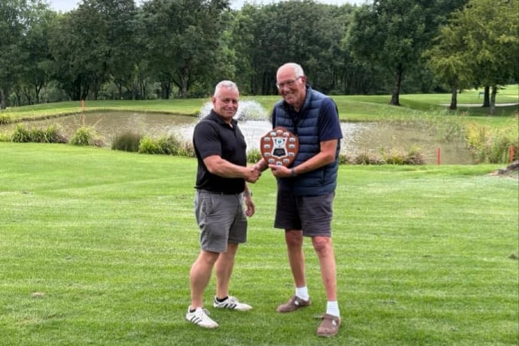 Club Captain Steve Jones, who its ex-Royal Navy, presenting the trophy to Gerry Woodley.