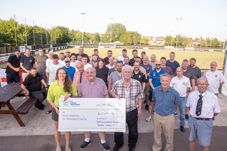 Richard Cooper, Roger Sanson, Clive Wilkes and Max Morgan along with representatives of North Gloucestershire League clubs present a cheque with the running total raised to Sully Sullivan (left) of the Great Western Air Ambulance Charity.