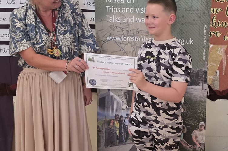 Ms Boon presenting the prize to Oscar - winner of the video category and overall competition