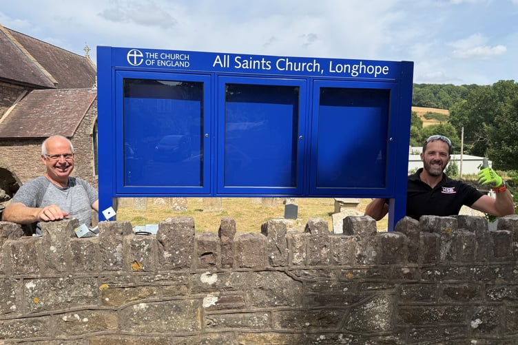 Friends of Longhope Church volunteers Rob Hillier and Matt Armstrong with the new noticeboard.