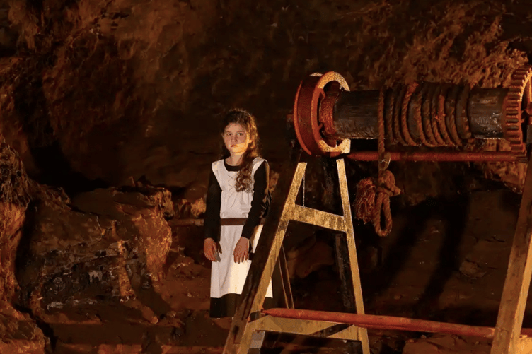 A young model recreates the experience of Victorian child labour during the Forest of Dean Camera Club's historical photoshoot at Clearwell Caves.
