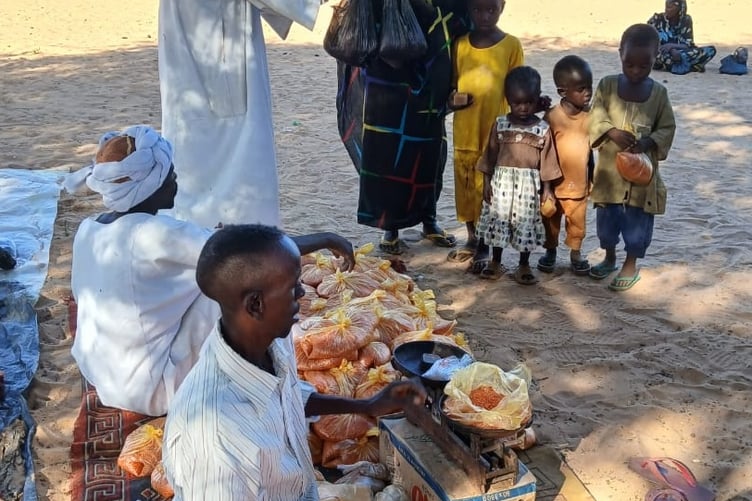 Family in Darfur receiving kids kitchen kit