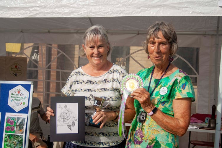 Marion Stanton with the drawing of a rose which won her the Aunty Mabel award for the best exhibit in the handicraft section.