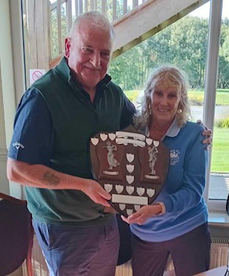 Kev Doyle and Carol Verrier with the Seniors v Ladies Trophy.
