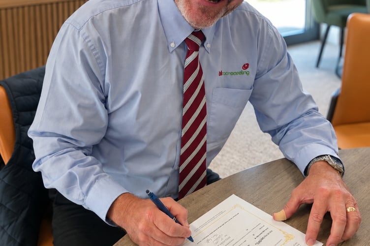 Pete Bell signs the documents transferring Bell Contracting to the Employee Ownership Trust.