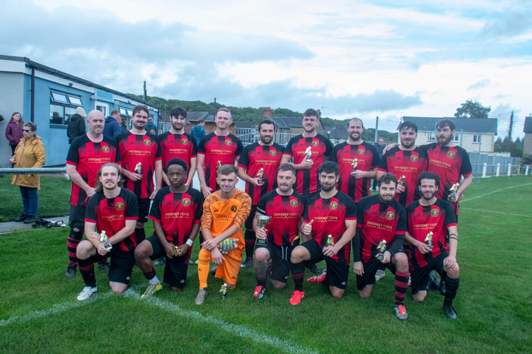 The Redbrook team pictured with the cup: Jason Powell, Robert Evans, Jake Teague, Tom Wareham, Callum Wheatley, Matt Jones,Gareth Clarke Williams, Cai Dorrington, Dan Hudson. Front row: Madi Cox, Jayden Makondora, Theo Bowen, Scott Windley (capt), Ieuan Frost, Joe Reeves, Joe Stephens.