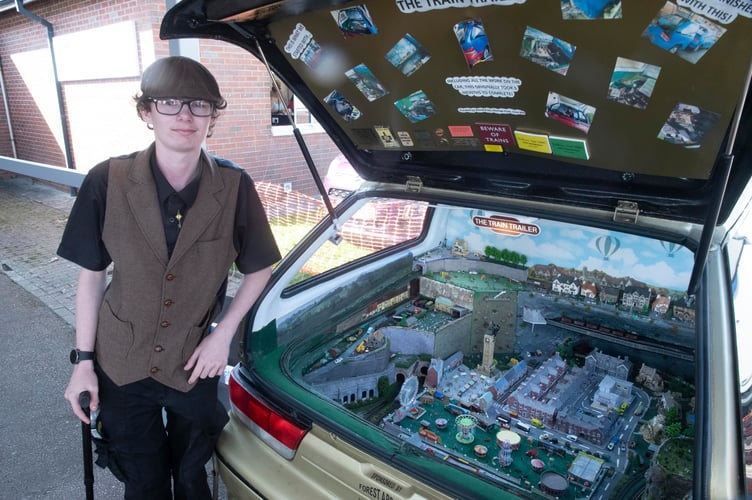 Tyler Brown with the Train Trailer in the back of an old car.