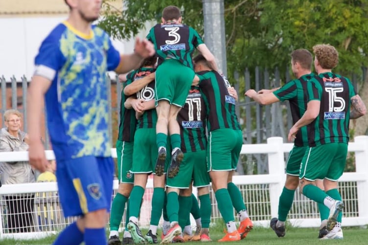 Cinderford Town players celebrate during their thrilling 3-2 FA Vase victory over Cheltenham Saracens, secured by Jordan Annear's stoppage time winner.