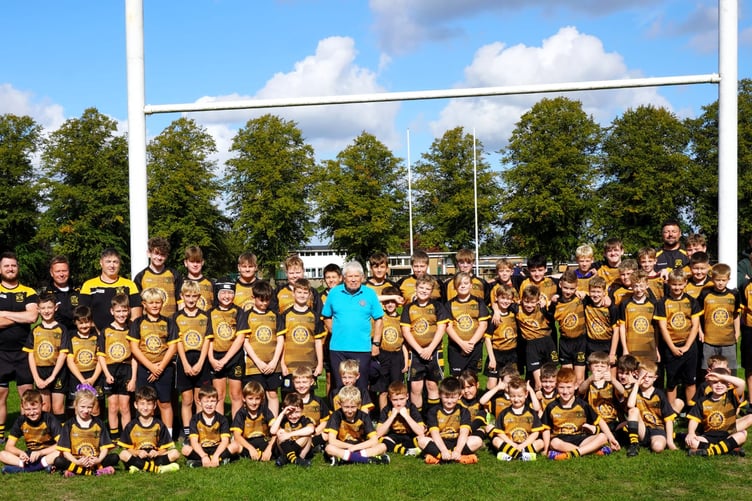Young players from Berry Hill RFC celebrated receiving new playing shirts funded by the Rotary Club of the Royal Forest of Dean, pictured alongside Rotarian John Belcher.