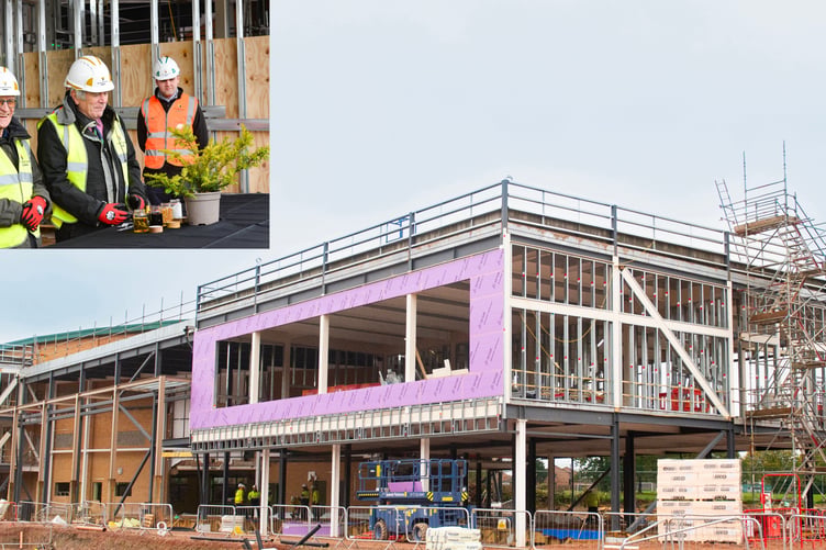 The construction of the new centre has reached its highest and (inset) the topping out ceremony to celebrate.